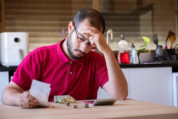 Stressed person worried about money choices